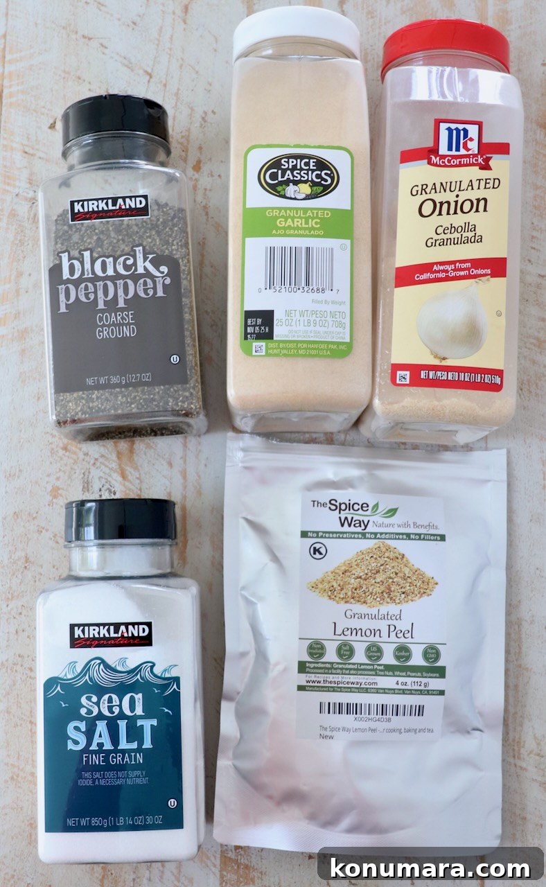 ingredients for lemon pepper seasoning on white wood board