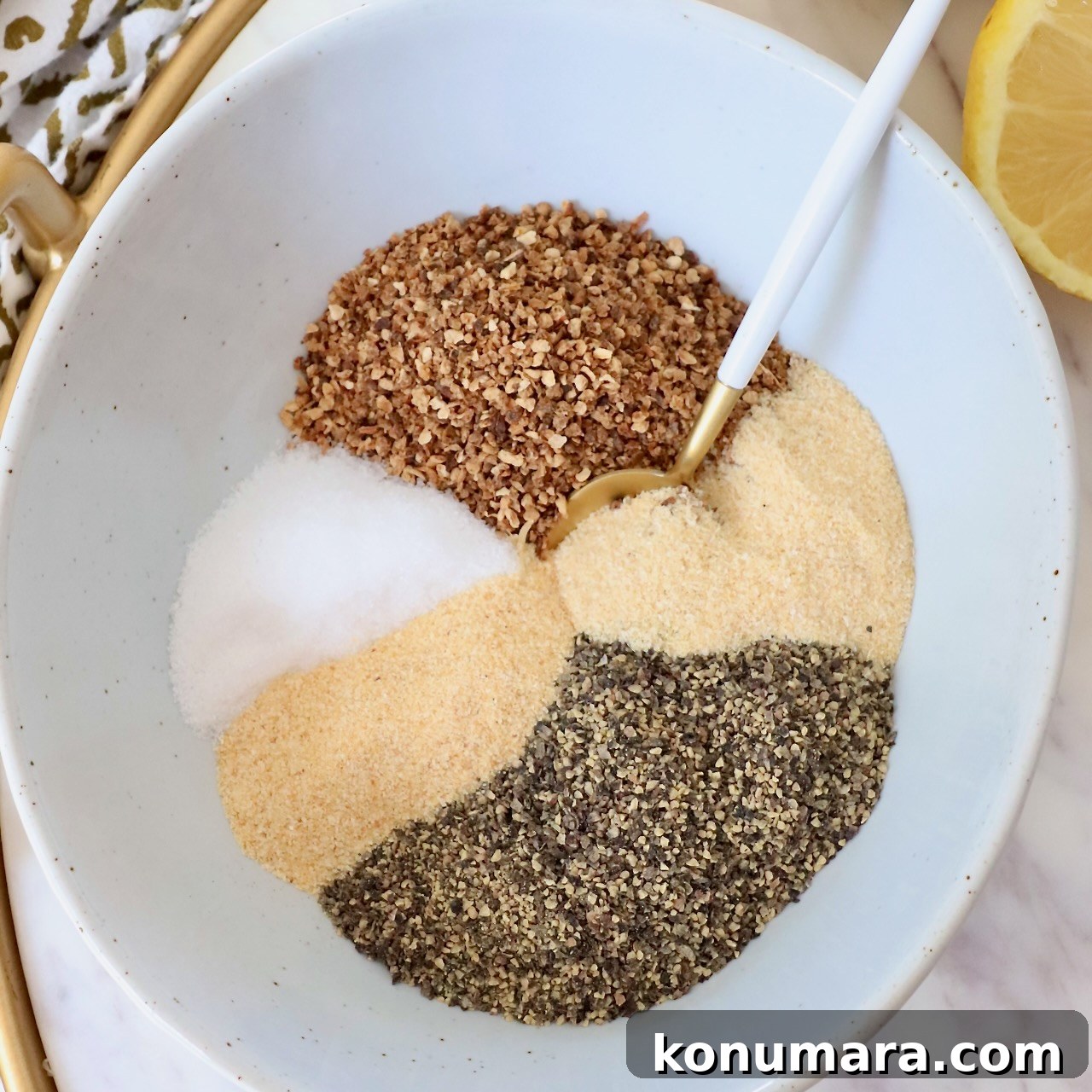 spices separated in bowl with spoon