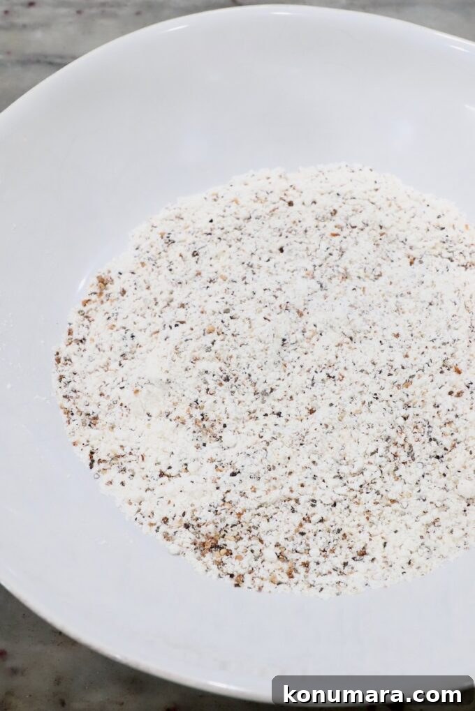 Crispy Lemon Pepper Chicken Recipe with Garlic Butter 4 flour combined with lemon pepper seasoning in white bowl
