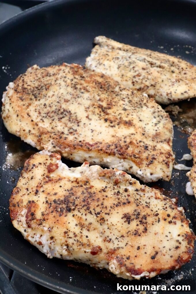 Crispy Lemon Pepper Chicken Recipe with Garlic Butter 7 seasoned seared chicken breasts in skillet