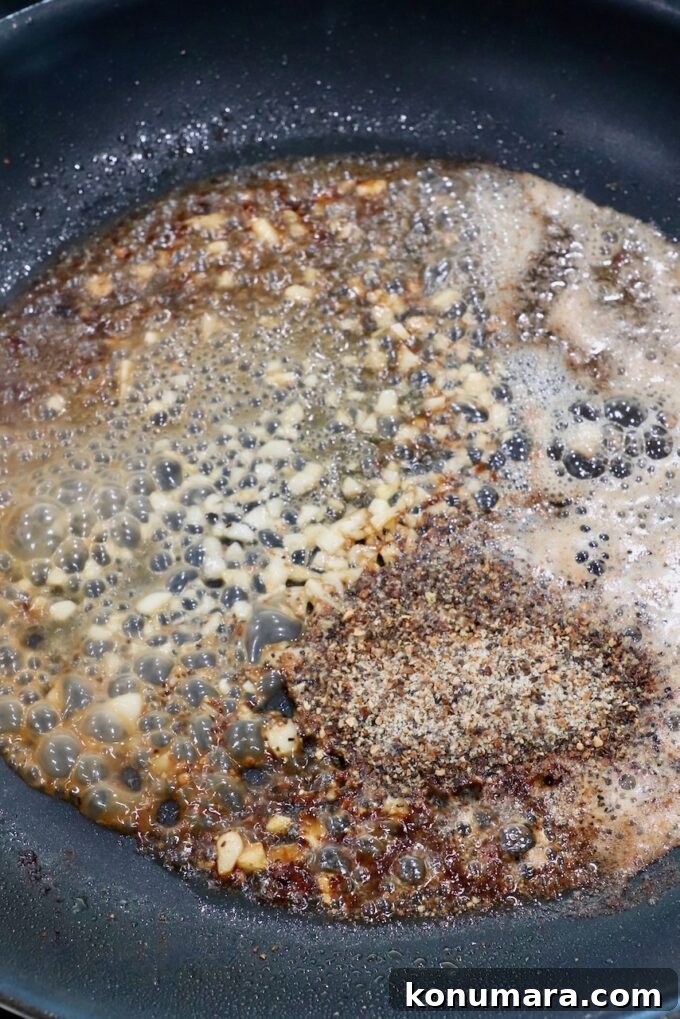 Crispy Lemon Pepper Chicken Recipe with Garlic Butter 8 seasoned butter in skillet