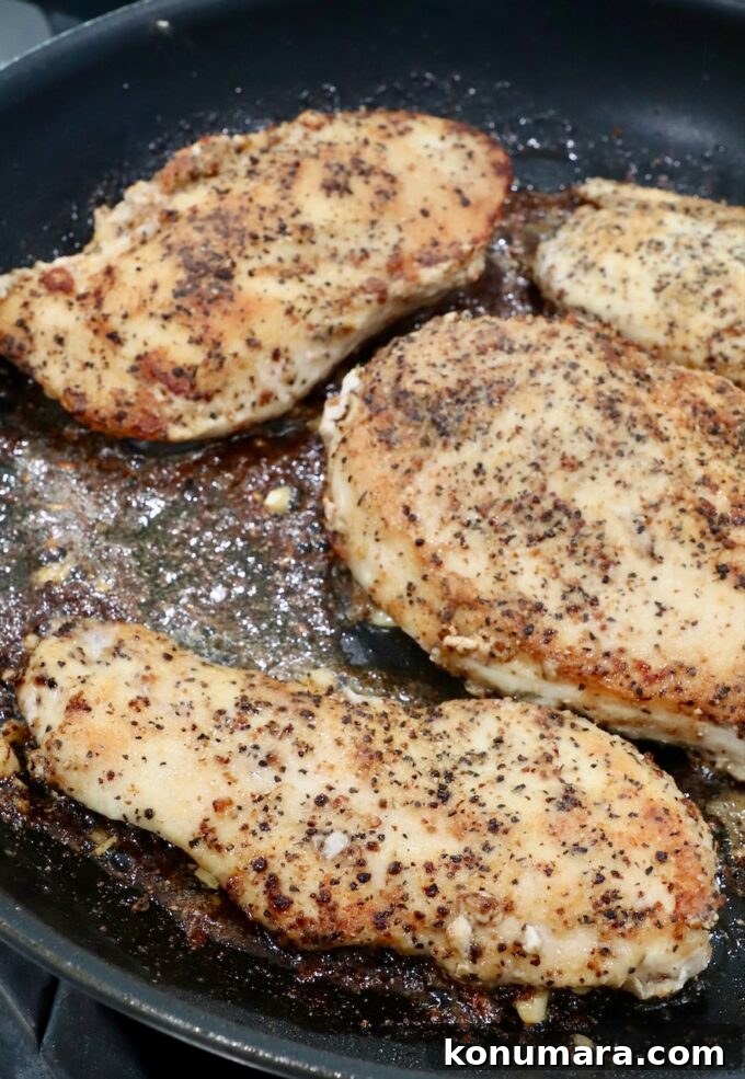 Crispy Lemon Pepper Chicken Recipe with Garlic Butter 9 cooked chicken in skillet
