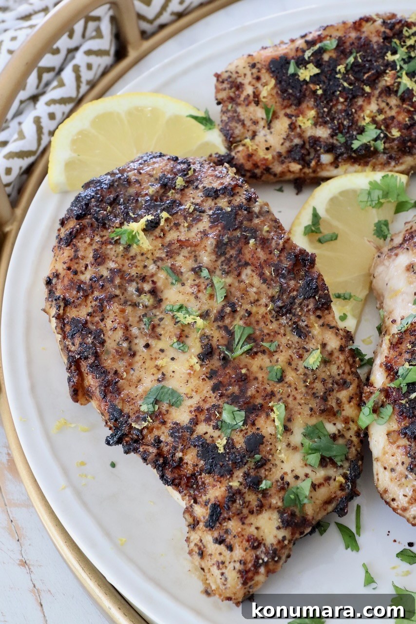 Crispy Lemon Pepper Chicken Recipe with Garlic Butter 10 lemon pepper chicken on plate with slices of lemon