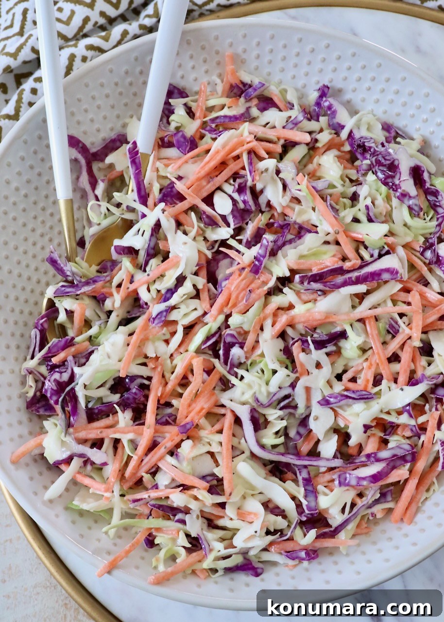 Classic Creamy Coleslaw Recipe 2 prepared coleslaw in large bowl with spoons