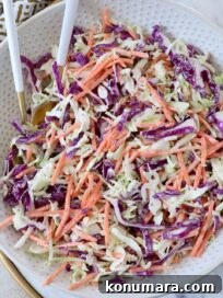 Classic Creamy Coleslaw Recipe 14 coleslaw in bowl with spoons