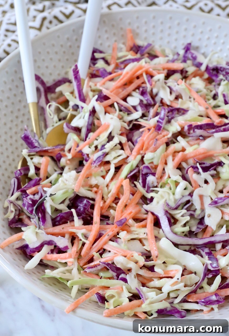 Classic Creamy Coleslaw Recipe 6 prepared coleslaw in bowl with spoons