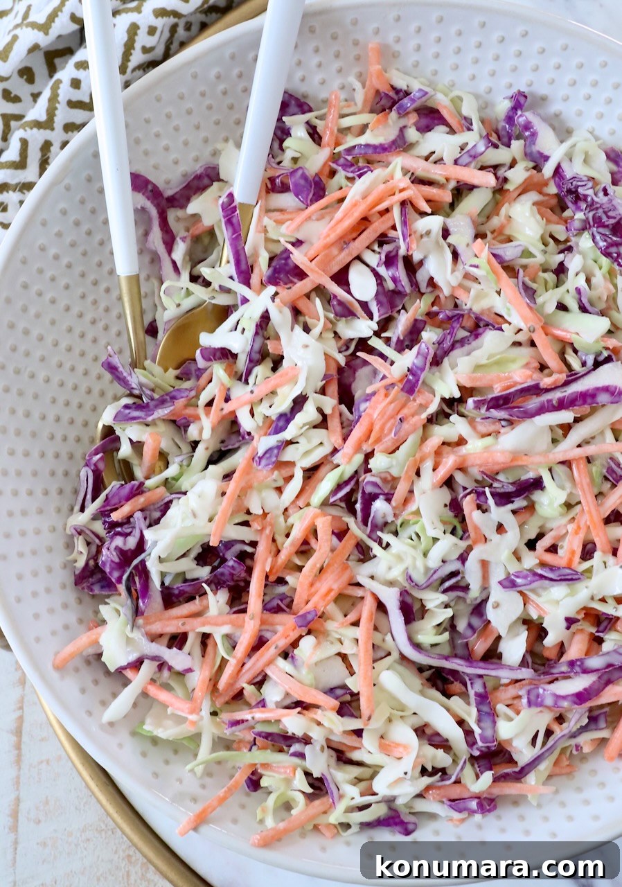 Classic Creamy Coleslaw Recipe 7 prepared coleslaw in bowl with spoons