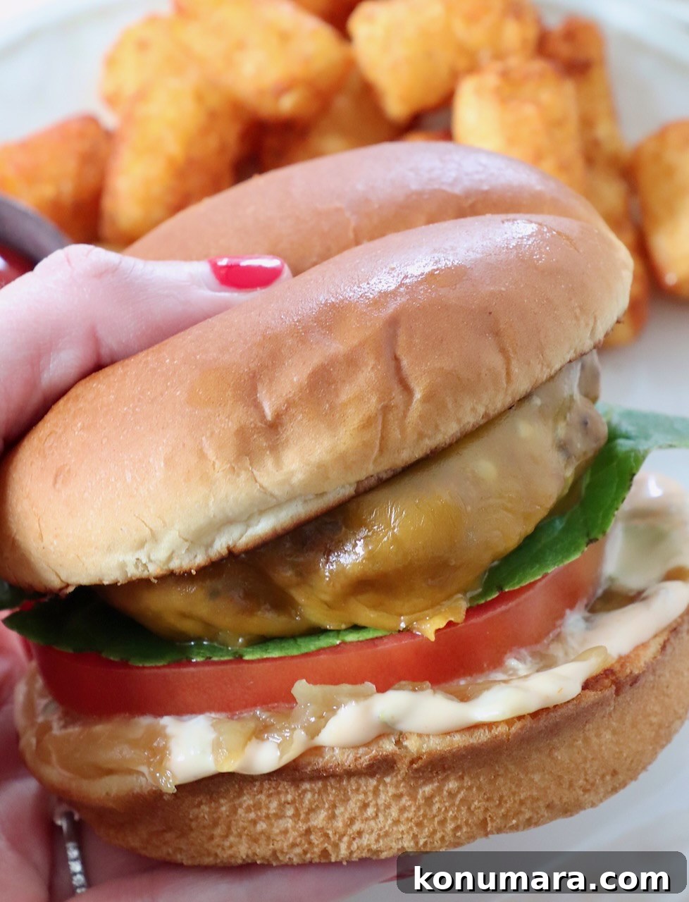 hand holding cheeseburger