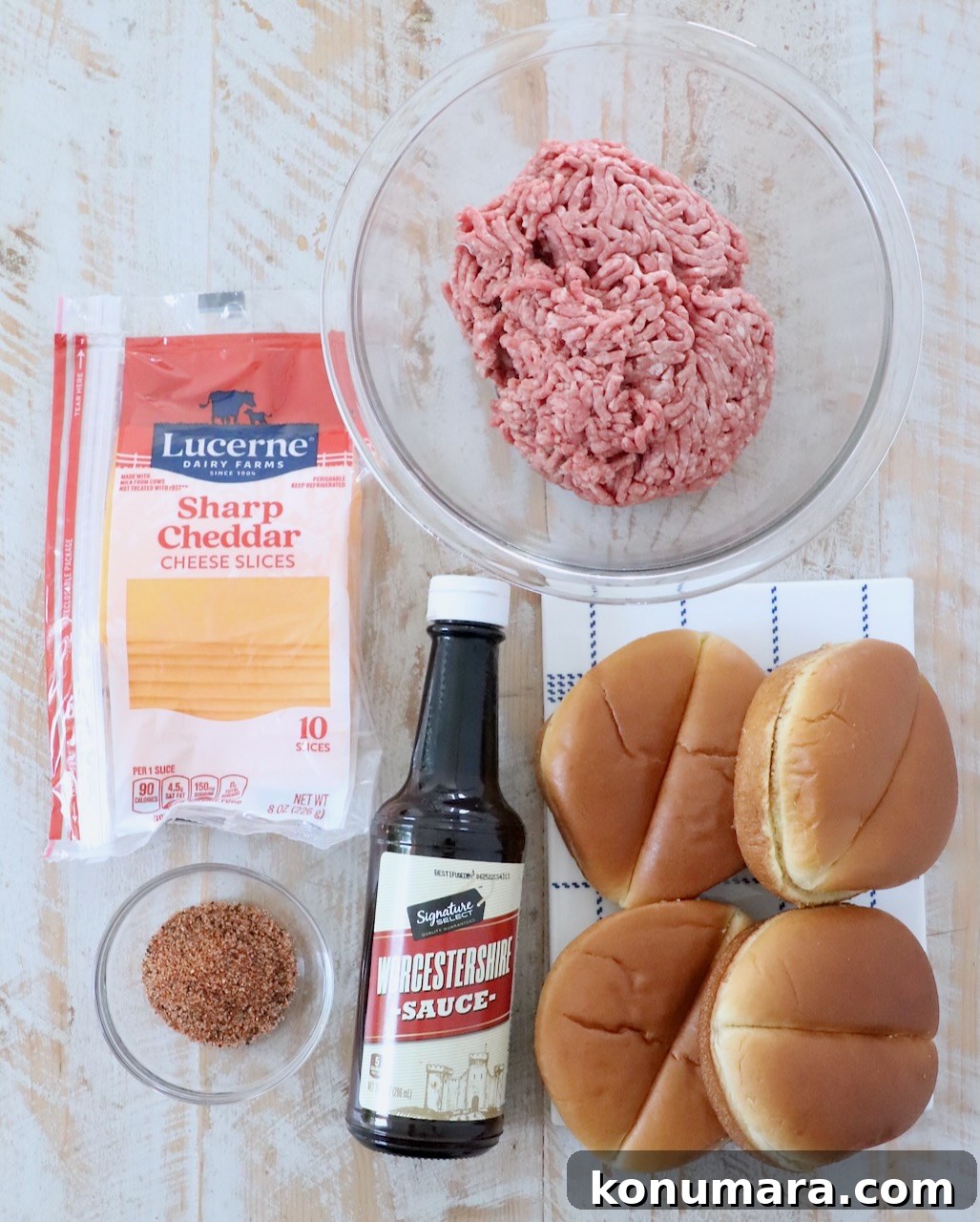 ingredients for air fryer cheeseburgers on white wood board
