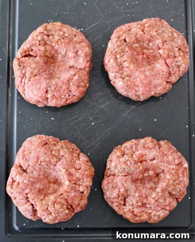 raw burger patties on cutting board