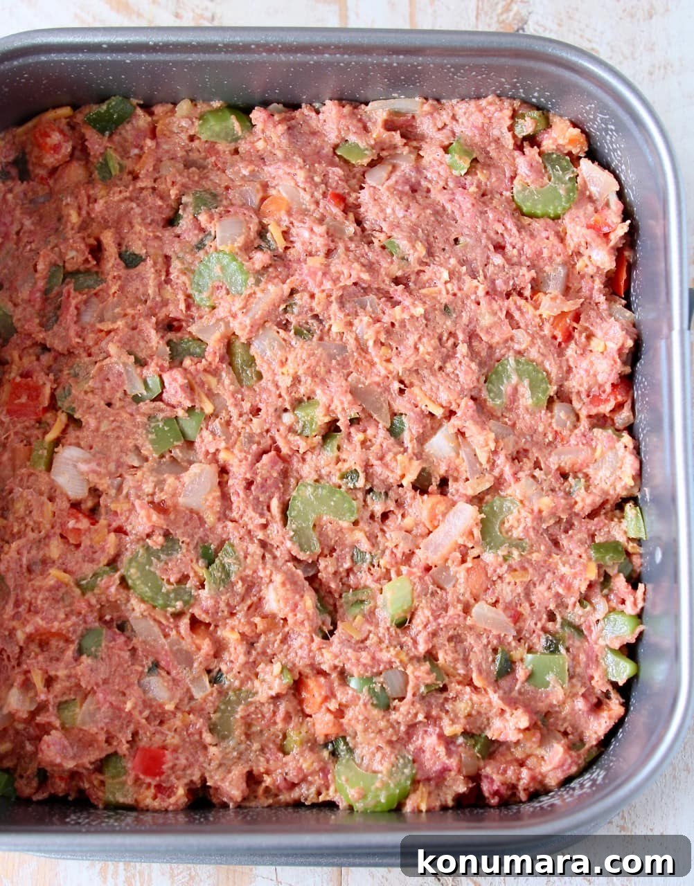 Uncooked mexican meatloaf in square springform pan