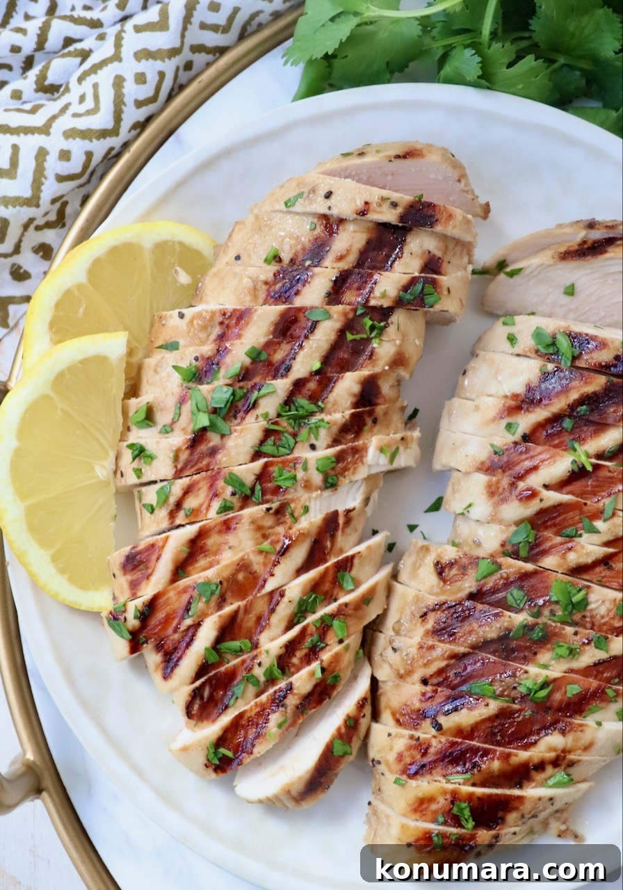 Garlic Lemon Chicken Marinade for Juicy Grilled Chicken 6 sliced grilled chicken on plate with lemon wedges