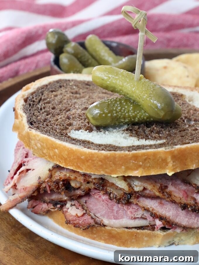pastrami sandwich on plate with cornichon pickles
