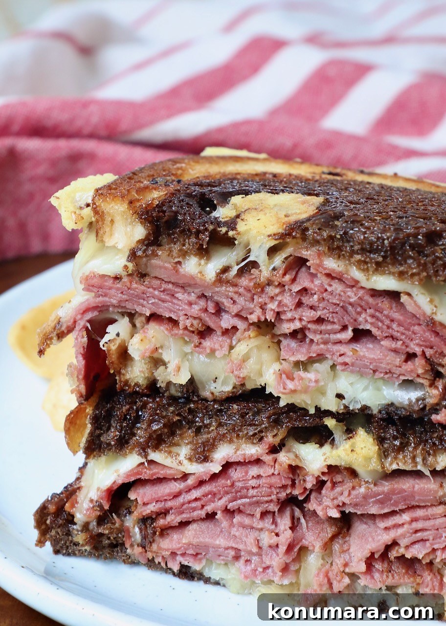Classic New York Pastrami Sandwich Recipe 2 hot pastrami sandwich sliced in half and stacked up on plate