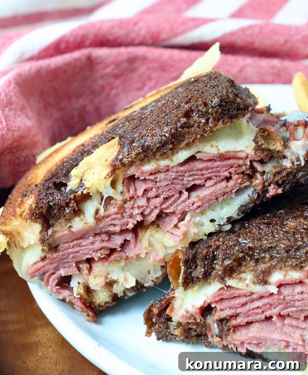 Classic New York Pastrami Sandwich Recipe 3 hot pastrami sandwich stacked up on plate