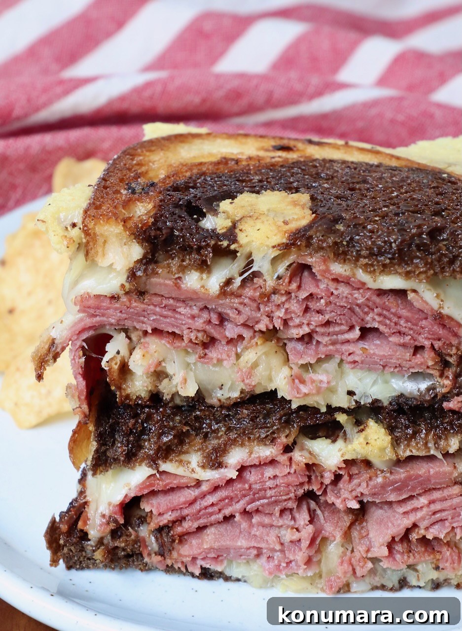 Classic New York Pastrami Sandwich Recipe 8 hot pastrami sandwich sliced in half and stacked up on a plate