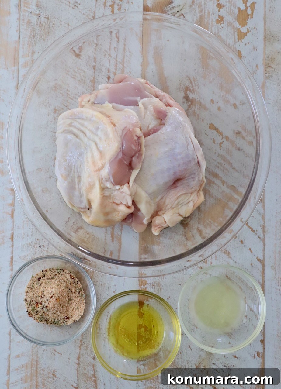 Crispy Garlic Air Fryer Chicken Thighs Recipe 3 ingredients for air fryer chicken thighs on white wood board