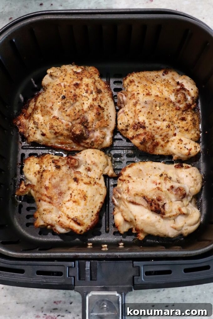 Crispy Garlic Air Fryer Chicken Thighs Recipe 5 partially cooked bone-in chicken thighs in air fryer basket