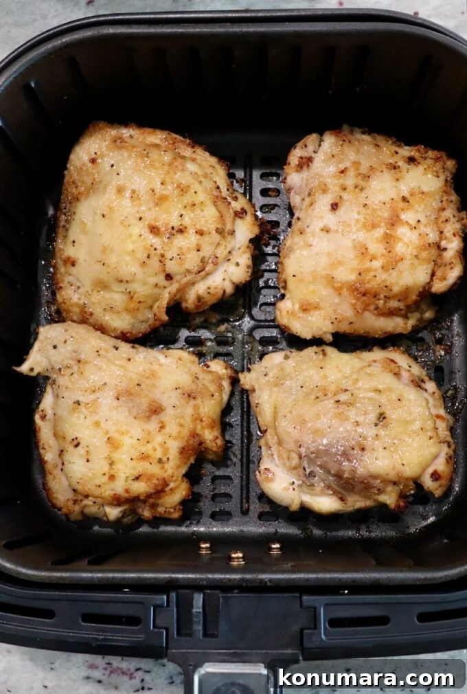 Crispy Garlic Air Fryer Chicken Thighs Recipe 6 partially cooked bone-in chicken thighs in air fryer basket