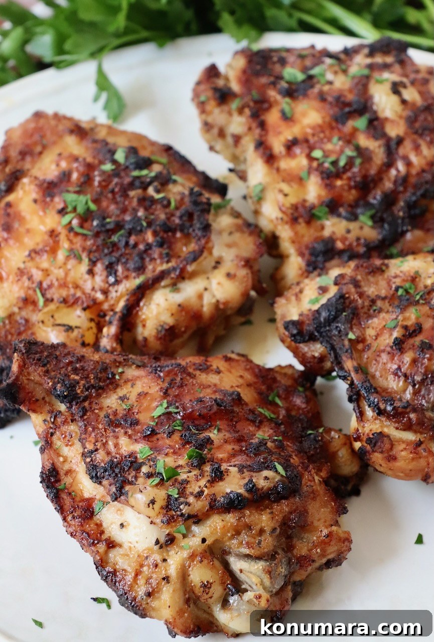 Crispy Garlic Air Fryer Chicken Thighs Recipe 8 cooked chicken thighs on plate