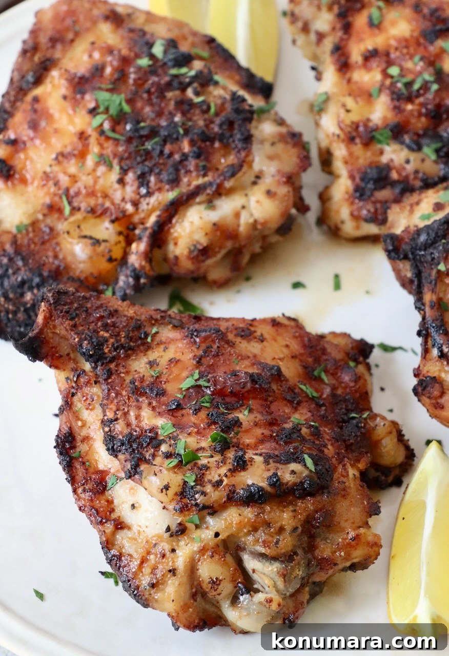 Crispy Garlic Air Fryer Chicken Thighs Recipe 9 cooked chicken thighs on plate