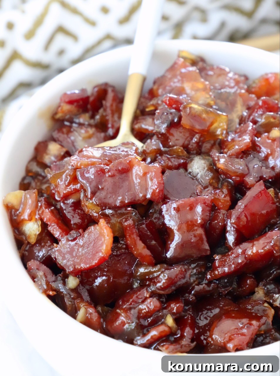Bacon jam in bowl with spoon, ready to serve