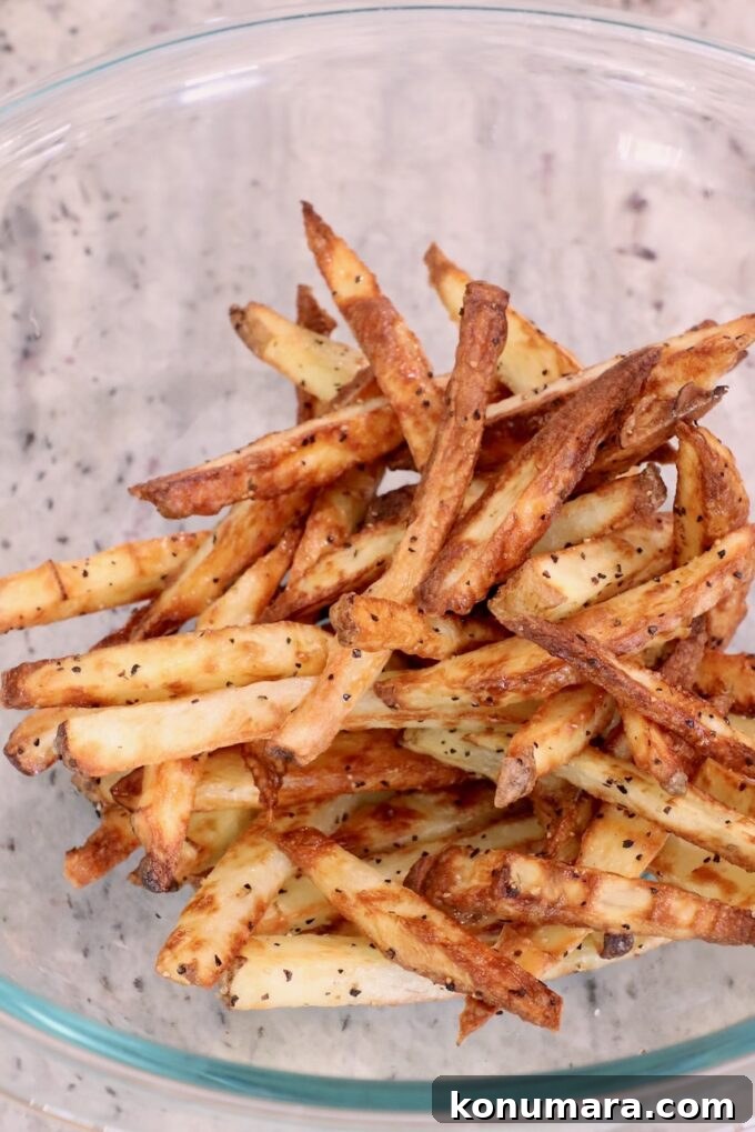 Crispy Truffle Fries with Garlic and Parmesan 7 seasoned cooked french fries in glass bowl