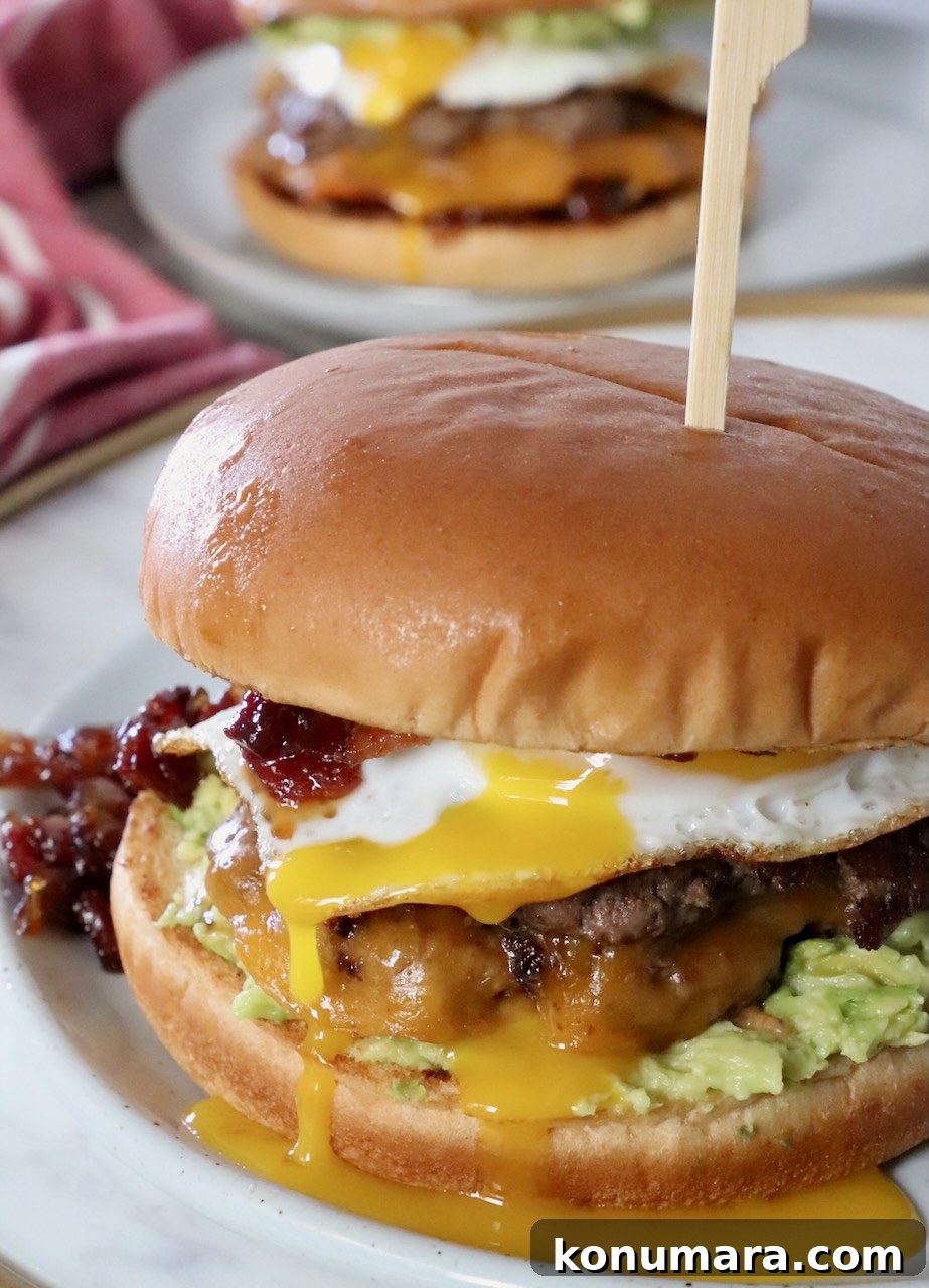 breakfast burger on plate with egg yolk dripping down the side