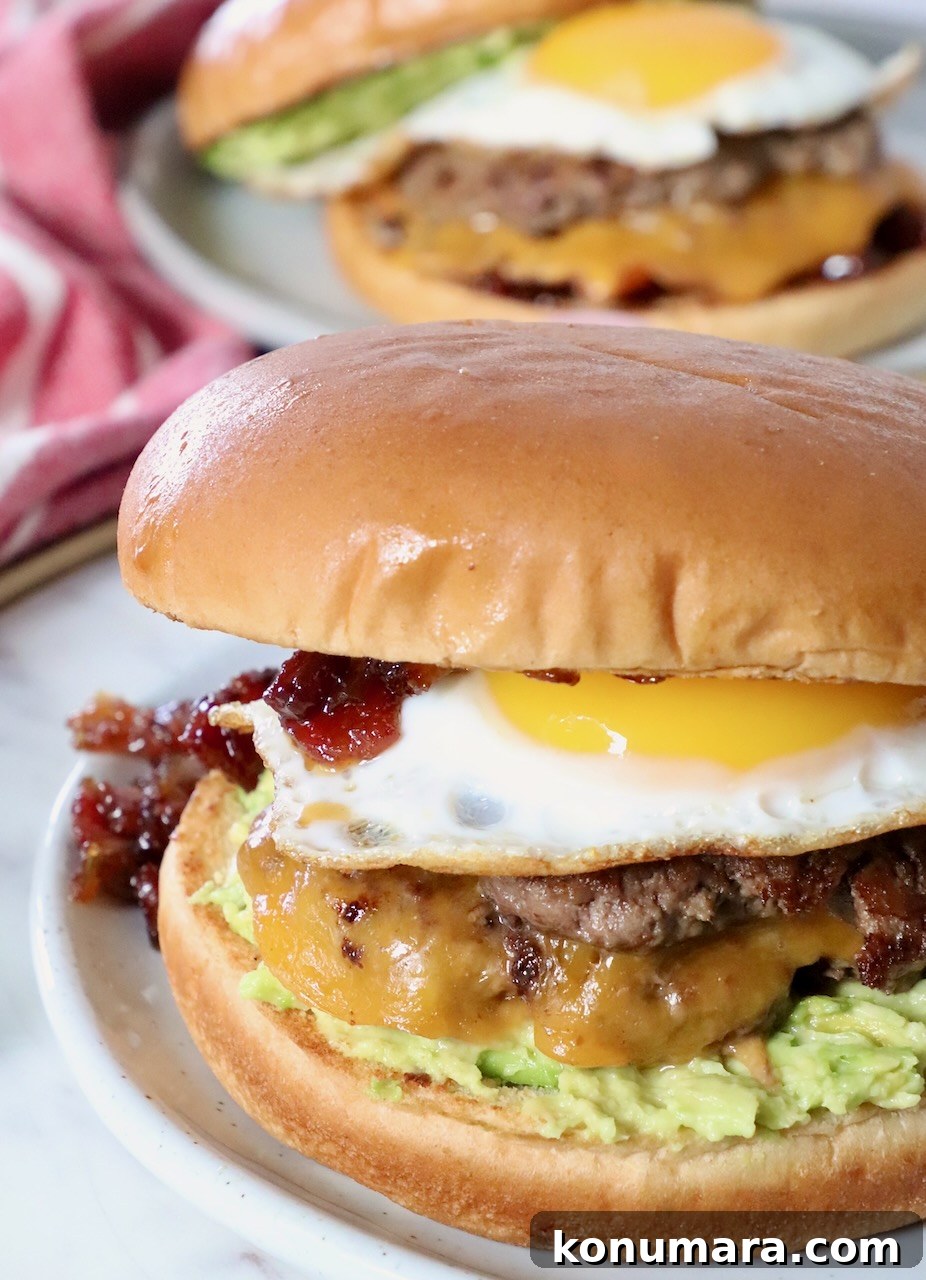 burger topped with egg on plate