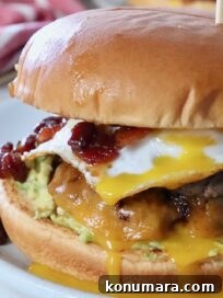 burger on plate topped with fried egg and bacon jam