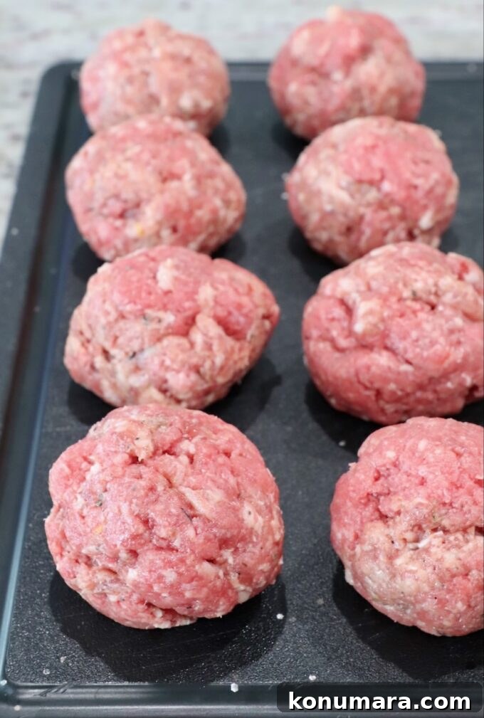 balls of beef and sausage on cutting board
