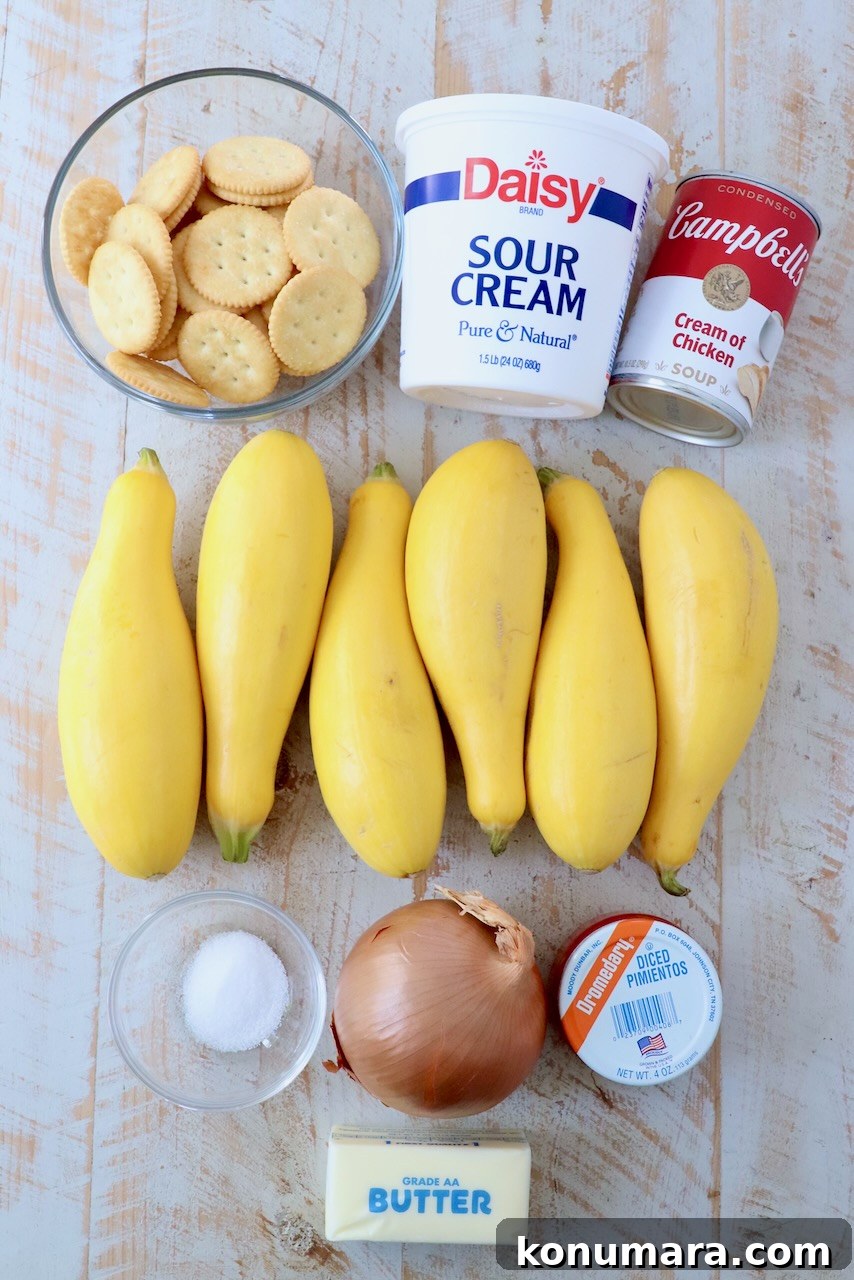 ingredients for squash casserole on white wood board