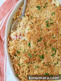 squash casserole in baking dish with serving spoon