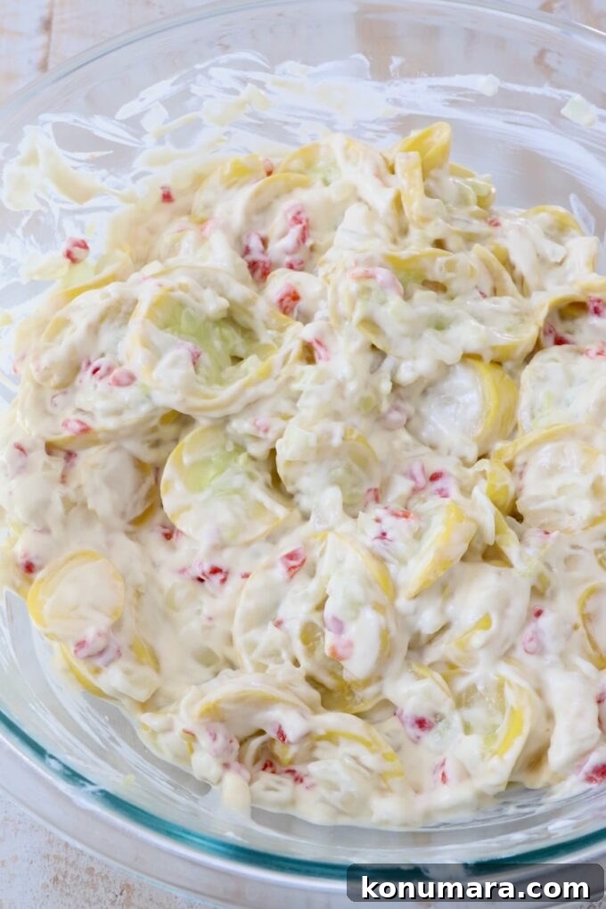 sliced yellow squash, cream of chicken soup, sour cream and pimentos combined in a glass bowl