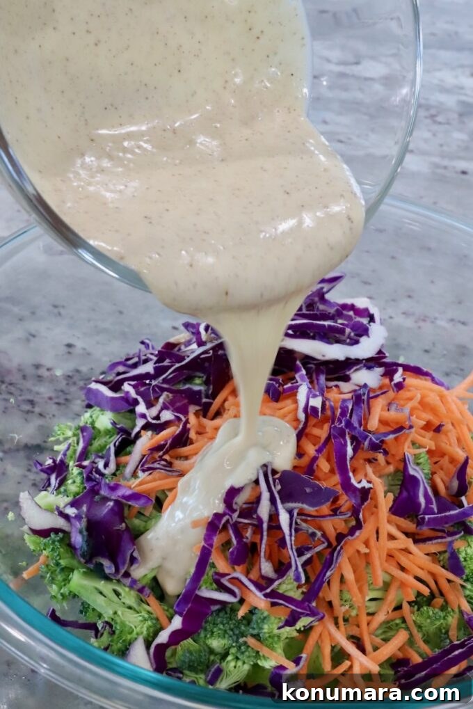 Crunchy Broccoli Slaw Recipe with Creamy Dressing 9 broccoli slaw in bowl with dressing poured over the slaw