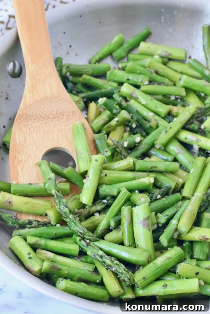 How to Cook Asparagus: Roasted, Grilled, Steamed and Sauteed 11 cooked asparagus in skillet with serving spoon