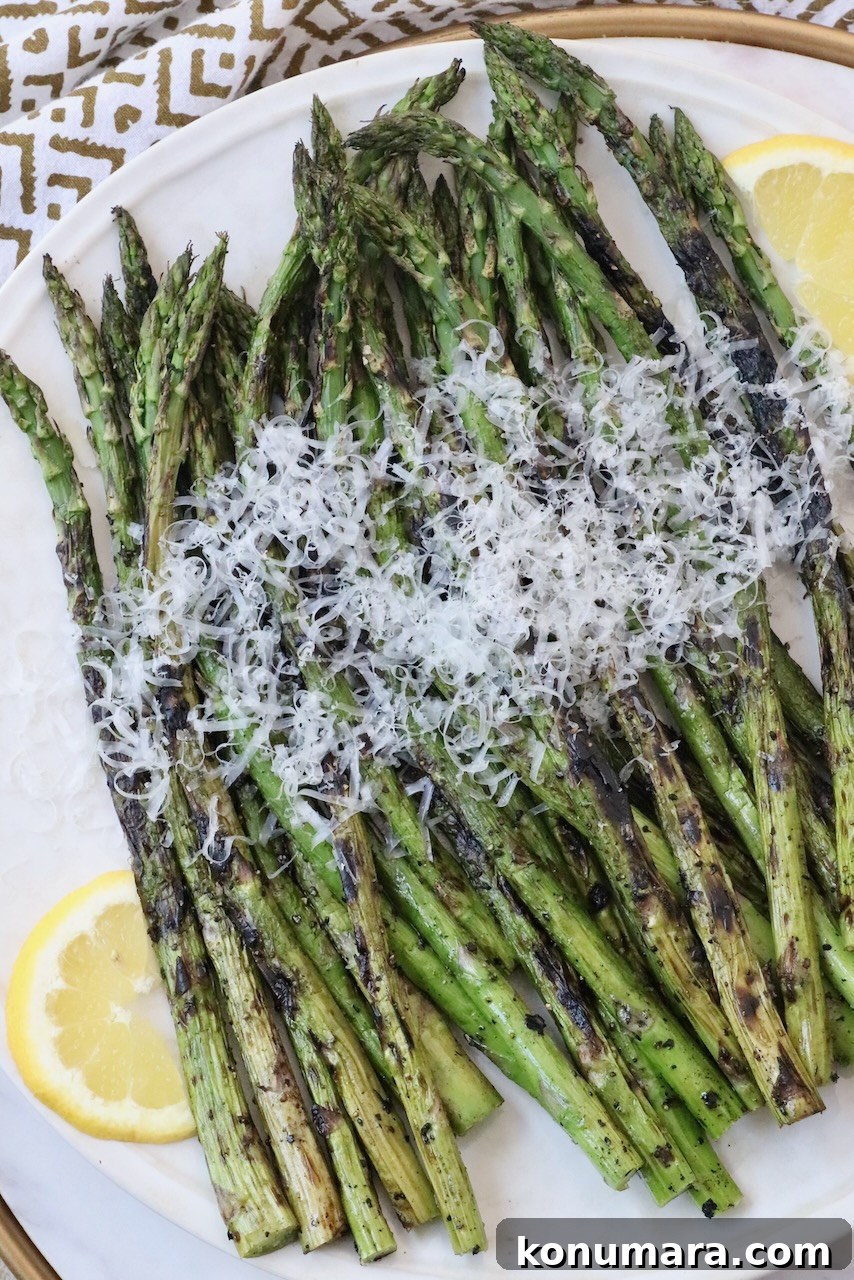 How to Cook Asparagus: Roasted, Grilled, Steamed and Sauteed 12 grilled asparagus topped with parmesan cheese on plate
