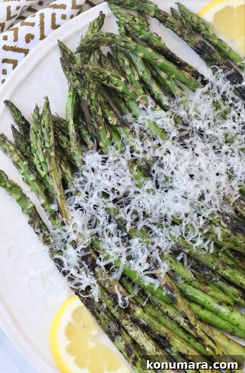 How to Cook Asparagus: Roasted, Grilled, Steamed and Sauteed 14 grilled asparagus on plate topped with grated parmesan cheese
