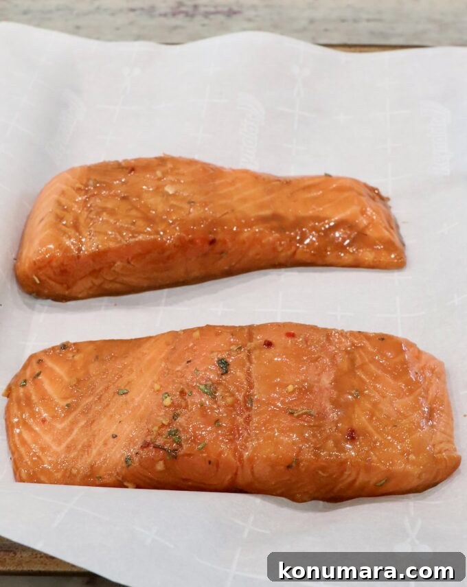 Garlic-Lemon Marinade for Salmon 5 marinated pieces of salmon on parchment-lined baking sheet