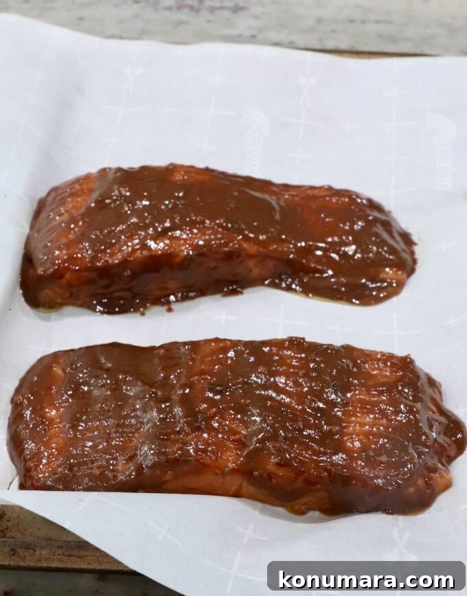 Garlic-Lemon Marinade for Salmon 7 glazed salmon on parchment lined baking sheet