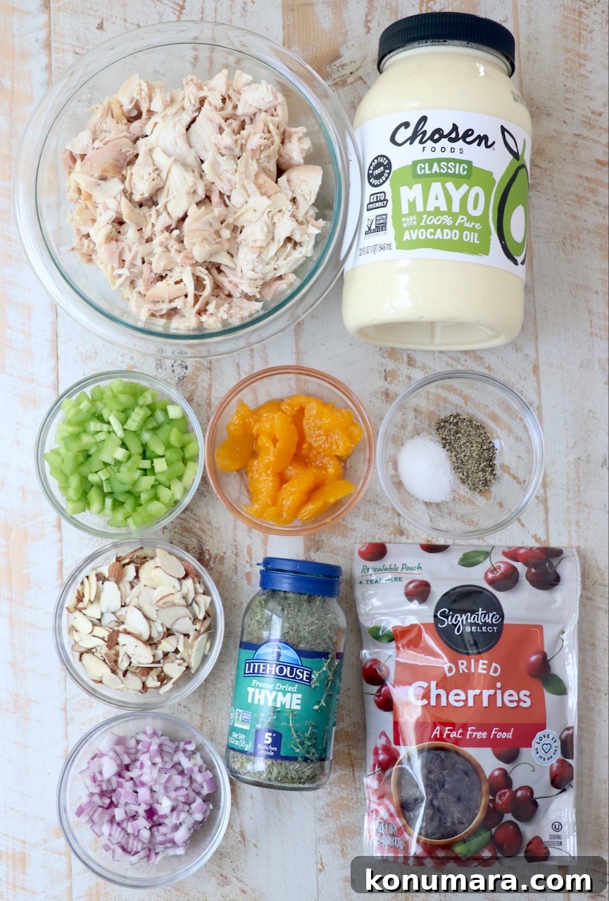Classic Creamy Chicken Salad with Celery and Fresh Herbs 3 ingredients for chicken salad on white wood board