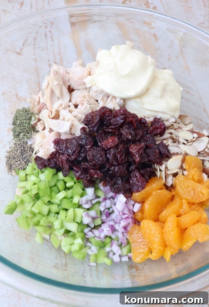 Classic Creamy Chicken Salad with Celery and Fresh Herbs 4 all ingredients for chicken salad separated in a large glass bowl