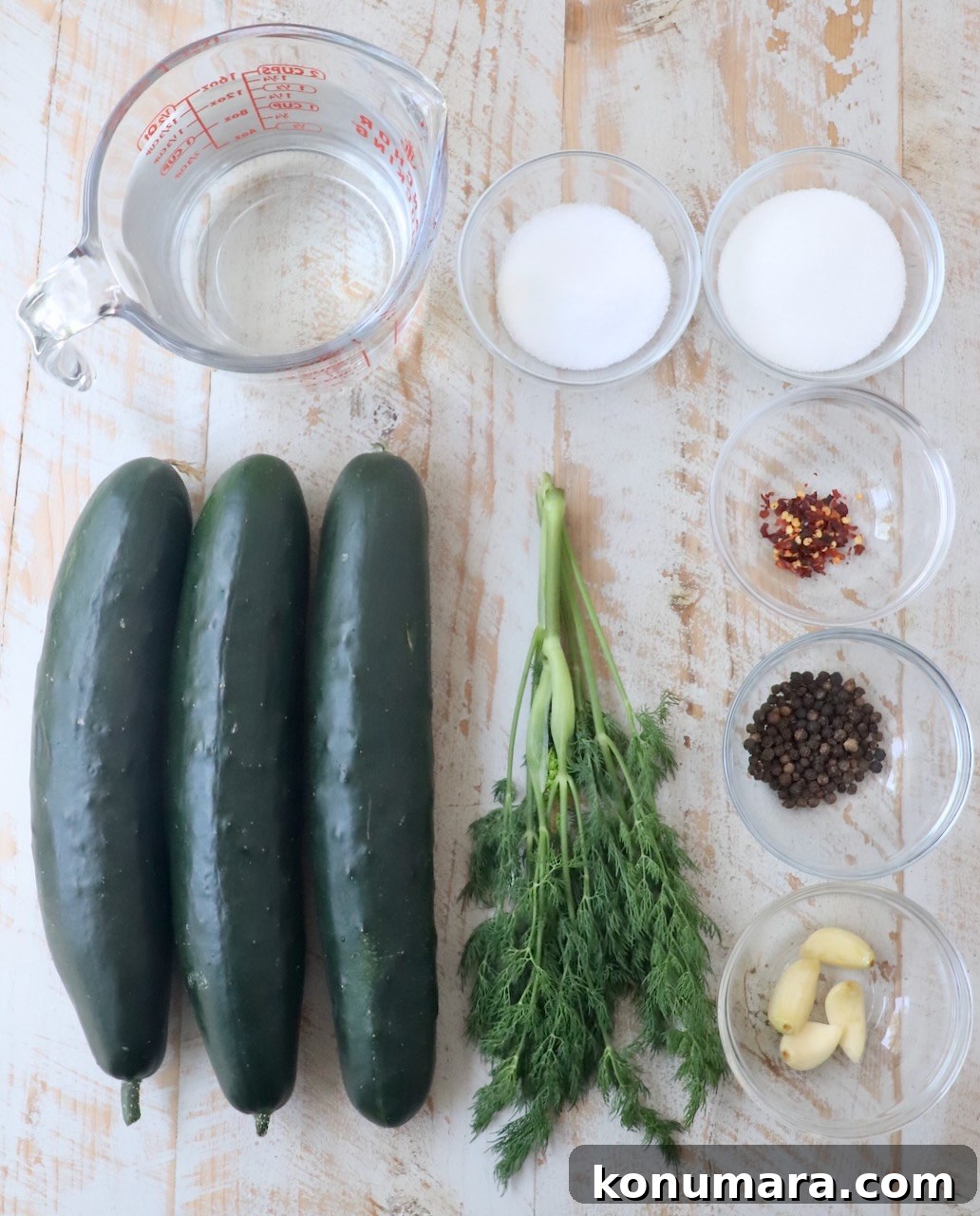 How to Make Homemade Pickles: Classic Refrigerator Recipe 3 ingredients for homemade pickles on white wood board
