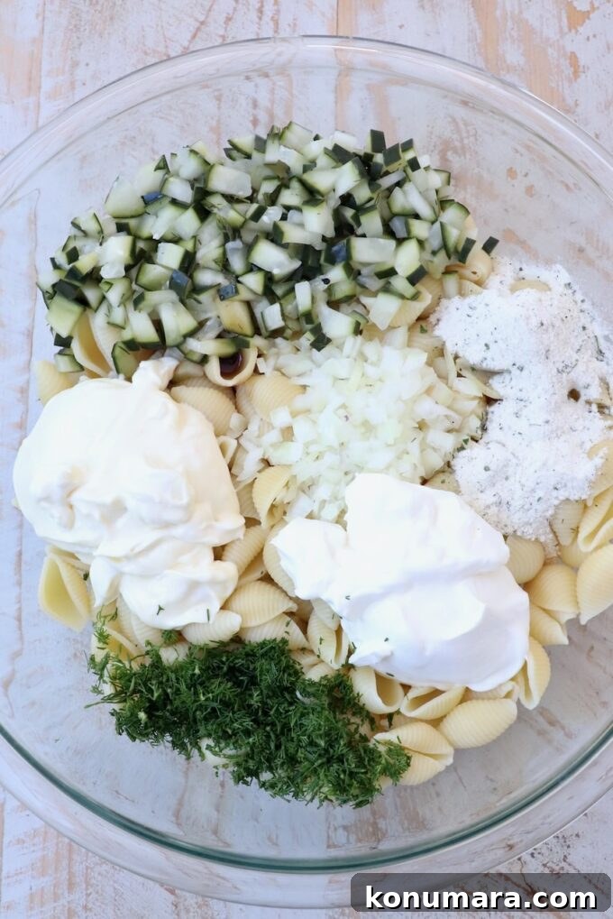 Creamy Tangy Pickle Pasta Salad 4 ingredients for pickle pasta salad separated in bowl