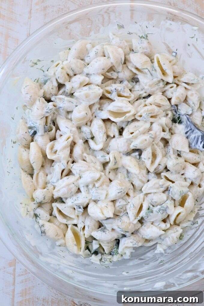 Creamy Tangy Pickle Pasta Salad 5 pickle pasta salad ingredients mixed together in large glass bowl