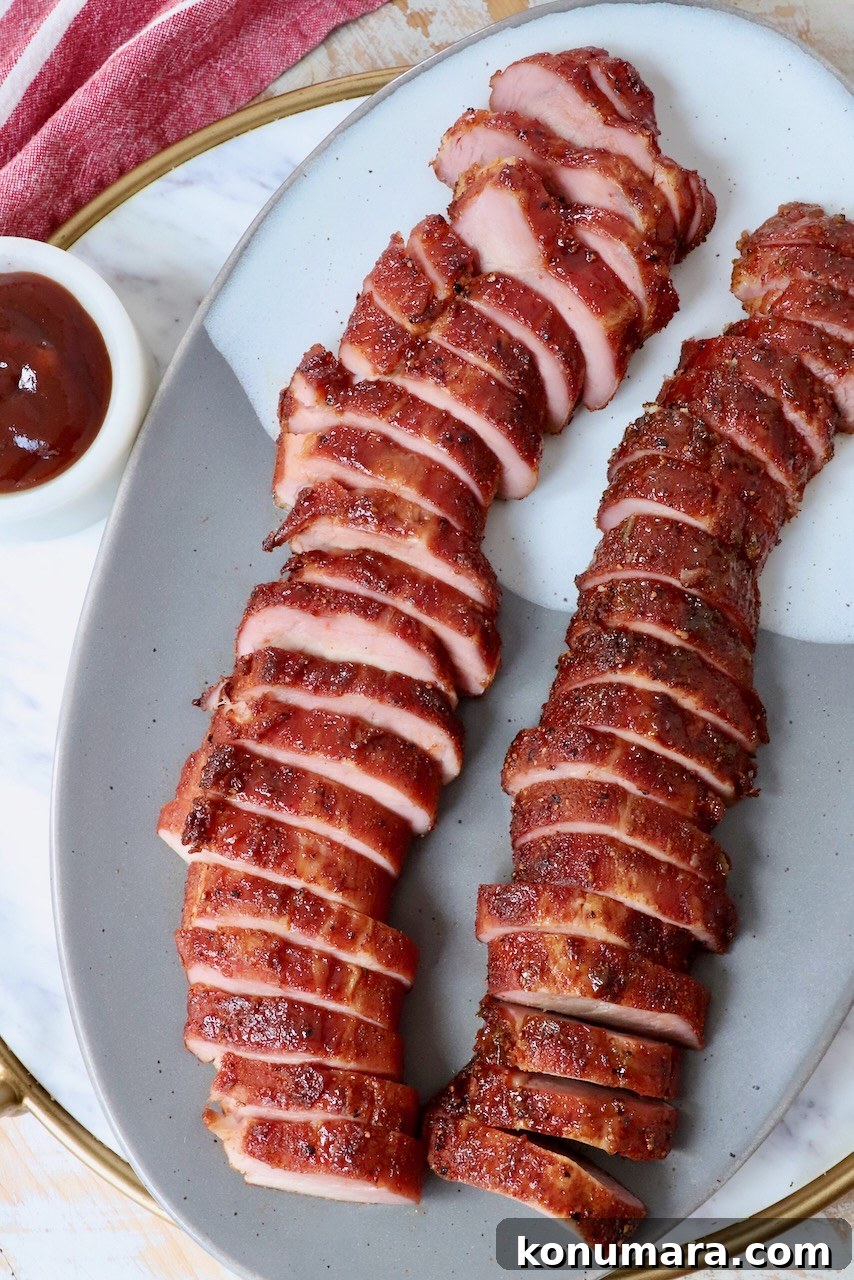 smoked pork tenderloin sliced on plate