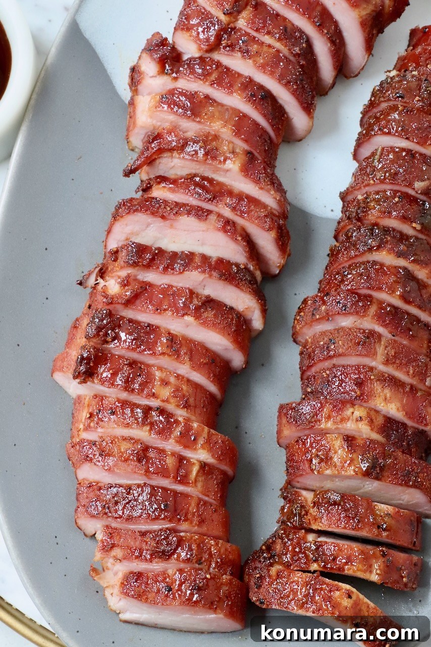 smoked pork tenderloin sliced on plate