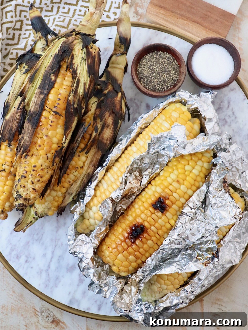 Grilled corn on the cob on marble platter