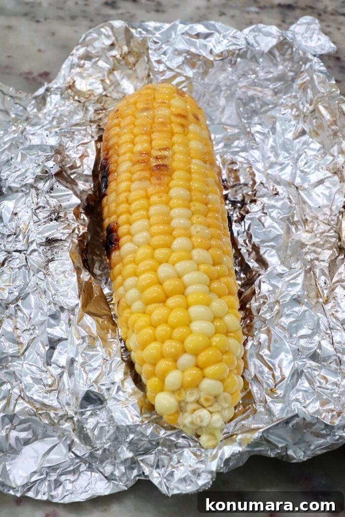 Grilled corn on the cob on a piece of foil