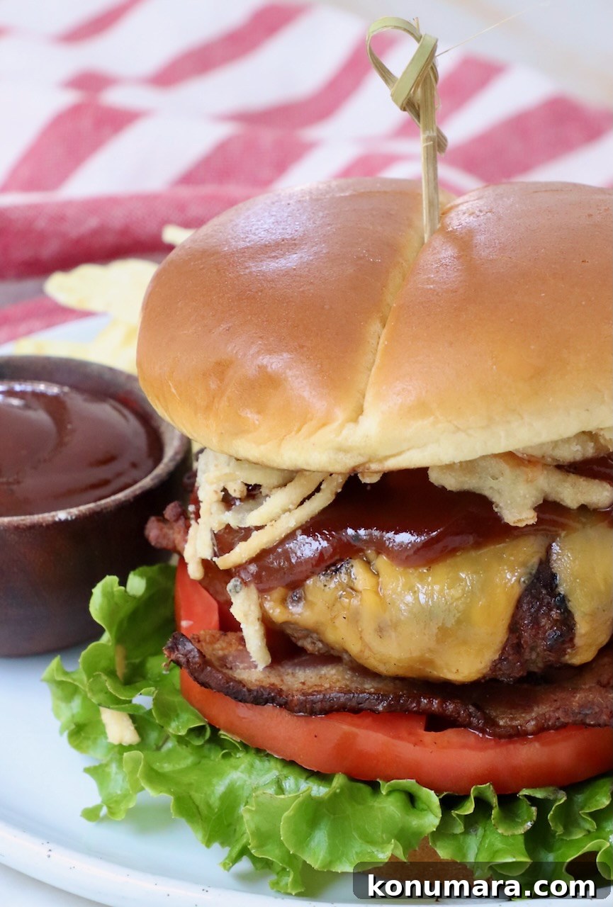 Smoky BBQ Bacon Burger Recipe 2 BBQ Bacon Burger on a plate with barbecue sauce